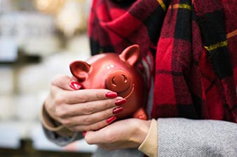 Woman lovingly holding a piggy bank