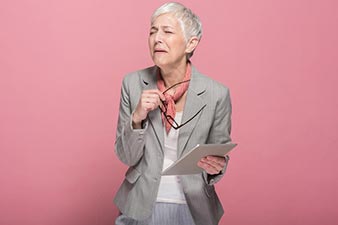 Older woman looking concerned at the contents of her iPad