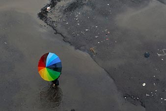 Rainbow umbrella on a rainy street