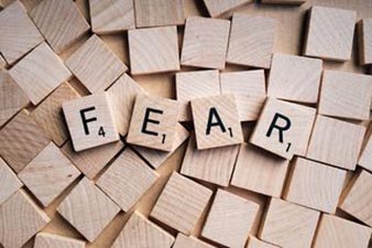 FEAR spelled out in scrabble tiles