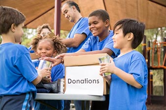 Children helping with donations
