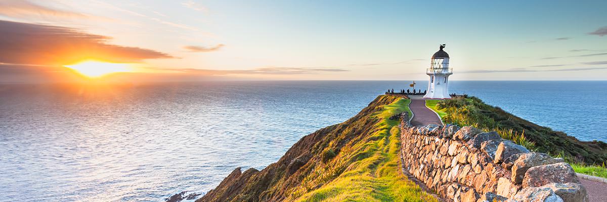 Looking across Cape Reinga lighthouse towards the sunset