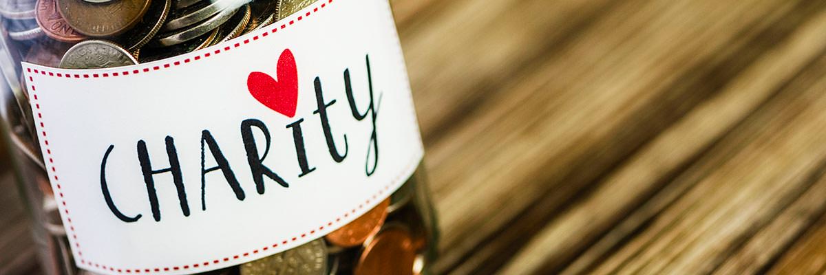 Charity collection jar full of coins