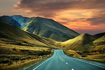 Driving towards a stormy sunset