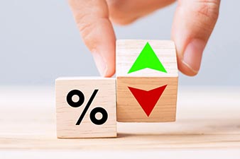 Two wooden dice, one with percentages and the other with gain and losss on different faces