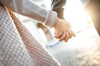 Two people holding hands